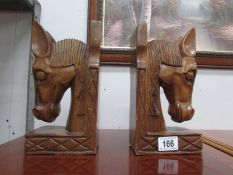 A pair of wooden horse head book ends.