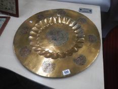A large brass tray featuring peacock.