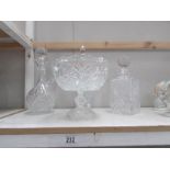 3 cut glass decanters and a cut glass fruit bowl.