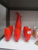 A vintage vibrant orange lemonade jug and 5 glasses.