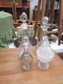 3 glass decanters and a lidded bowl.