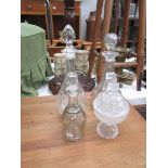 3 glass decanters and a lidded bowl.
