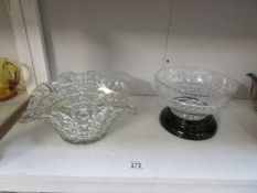 A glass bowl on stand + one other.