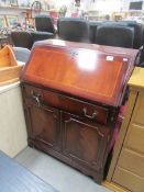 A mahogany effect bureau.