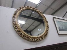 A gilt framed circular mirror.