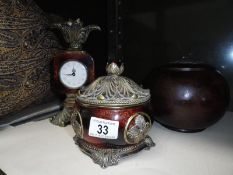 An ornament quartz movement clock with matching trinket pot and another trinket pot