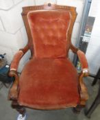 A victorian deep buttoned carver chair.