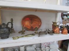 A shelf of brass and copper etc.
