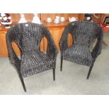 2 black wicker chairs.