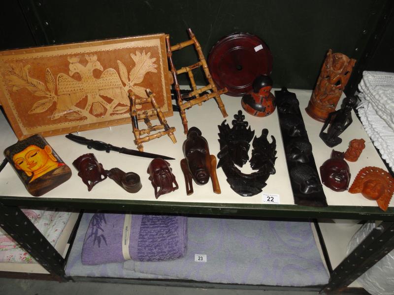 An assortment of ornamental wooden items including masks, figures, tray, paper knife etc.