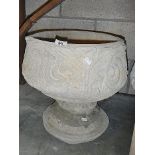 A fleur de lis urn depicting stylised 3 petal design.