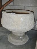 A fleur de lis urn depicting stylised 3 petal design.