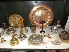 An assortment of metal ware including bells, inkwell, plaques etc.