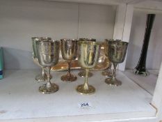A silver plated dish and 7 goblets.