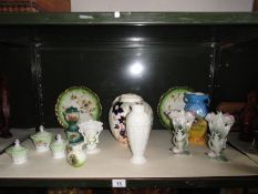 A shelf of assorted ceramic ware consisting of vases, plates, trinket pots etc.