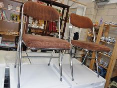 A pair of retro style folding chairs.