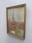 A framed and glazed watercolour of a church.