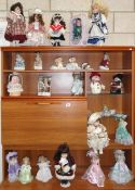 A quantity of porcelain dolls etc.