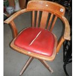 An Edwardian oak swivel office chair.