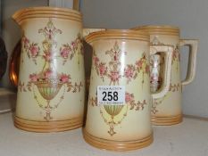 A set of 3 graduated crown devon jugs.