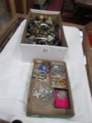 A shoebox of costume jewellery and a tray of diamonte jewellery.