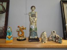 A quantity of chinese figures, including dragon and foo dog.