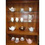 A quantity of teapots, jugs etc.