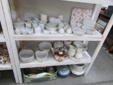 3 shelves of assorted kitchen and table wate.