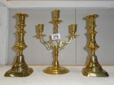 A pair of brass candlesticks and 3-branch brass candelabra.