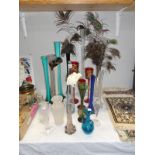 A quantity of posy vases, including peacock feathers.
