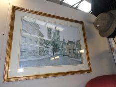 A framed and glazed print of Lincoln cathedral from castle square.