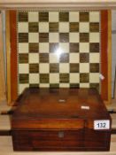 A chess board and wooden box and contents.