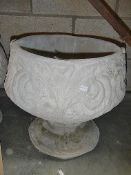 A fleur de lis urn depicting stylised 3 petal design.