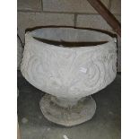 A fleur de lis urn depicting stylised 3 petal design.