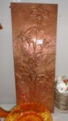 A hammered copper wall plaque.