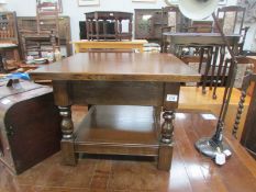 A low oak table with drawer and gallery.