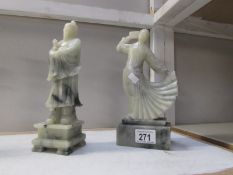 A pair of oriental carved stone figures.