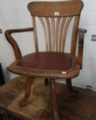 An oak office swivel chair.