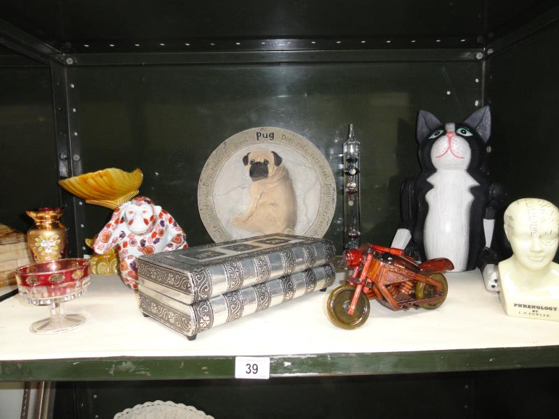 A shelf of assorted items including Fowler Phrenology bust,