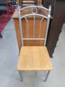 A metal chair with wood seat.
