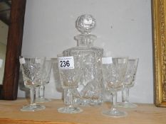 A glass decanter and 5 glasses.