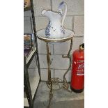 A metal wash stand with jug and basin,