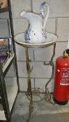 A metal wash stand with jug and basin,