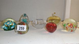 7 assorted glass paperweights.