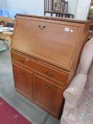 A modern teak bureau.