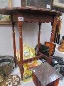 An oak pie crust edge occasional table.