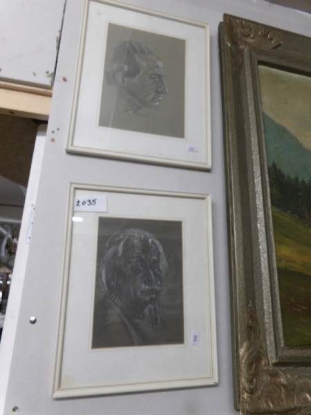 A framed and glazed portrait of Albert Einstein and one other.