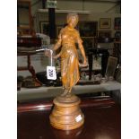 A metal figure of a lady with plaque to base 'Modistie'.