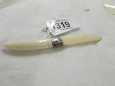 An ivory and silver letter opener.