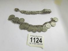 An silver Irish coin bracelet and a silver gate bracelet.